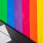 Imagem da bandeira Queer com uma pasta dizendo "im gay"