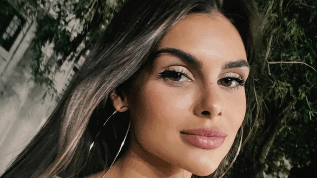 Amanda Kimberlly with long hair and hoop earrings