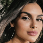 Amanda Kimberlly with long hair and hoop earrings