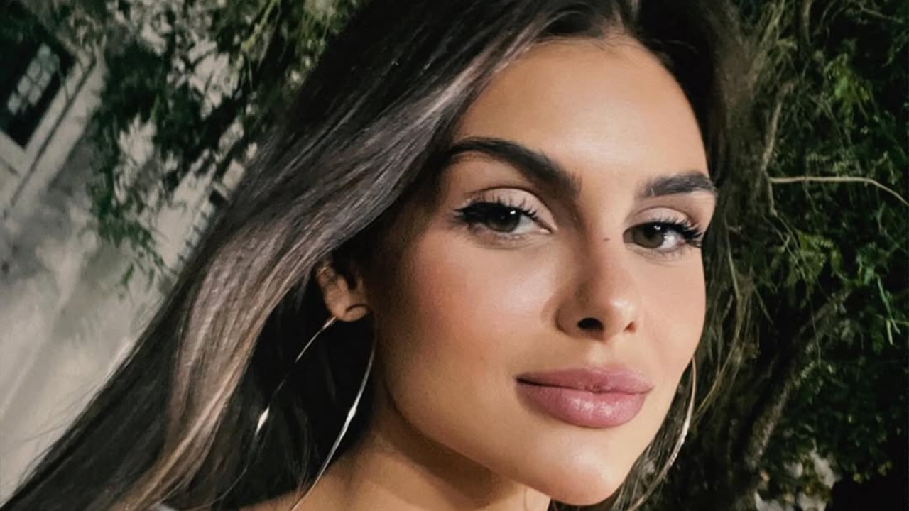 Amanda Kimberlly with long hair and hoop earrings